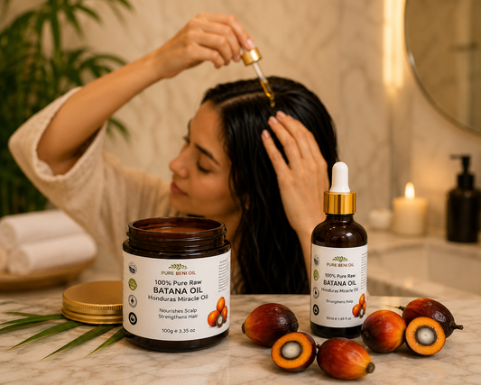 Woman applying Pure Beni Batana Oil to her hair in a luxury bathroom as part of a natural hair care routine.